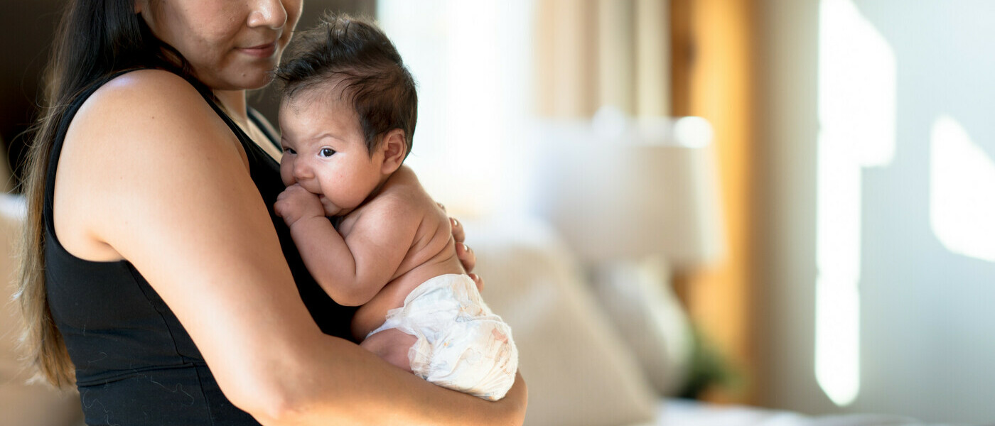 A woman holds a baby